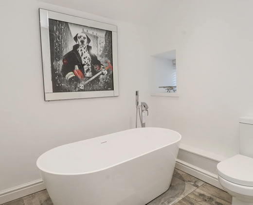 Family bathroom with bath and shower over at Ty'n Lon