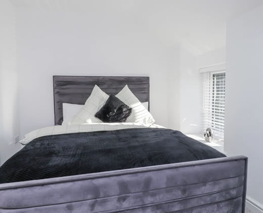 Comfortable double bedroom at Ty'n Lon farmhouse holiday home